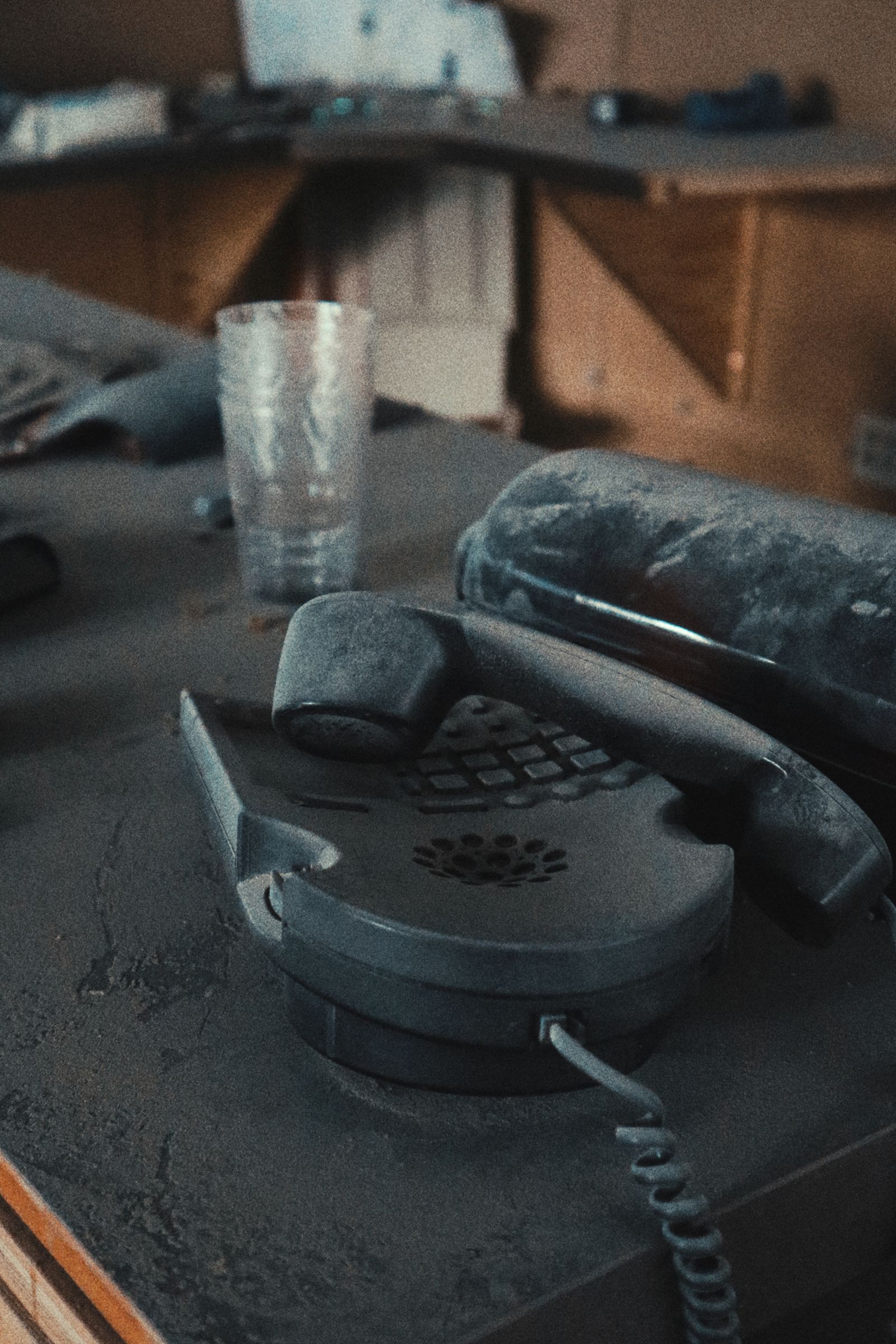 A dusty telephone left on an abandoned desk